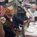 American House Sterling Heights, senior living community offering independent living and respite care in Sterling Heights, MI, residents celebrating Mardi Gras