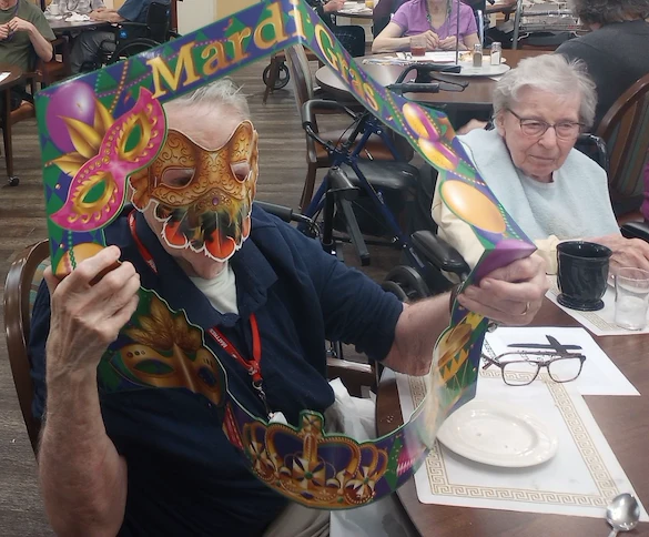 American House Sterling Heights, senior living community offering independent living and respite care in Sterling Heights, MI, residents celebrating Mardi Gras
