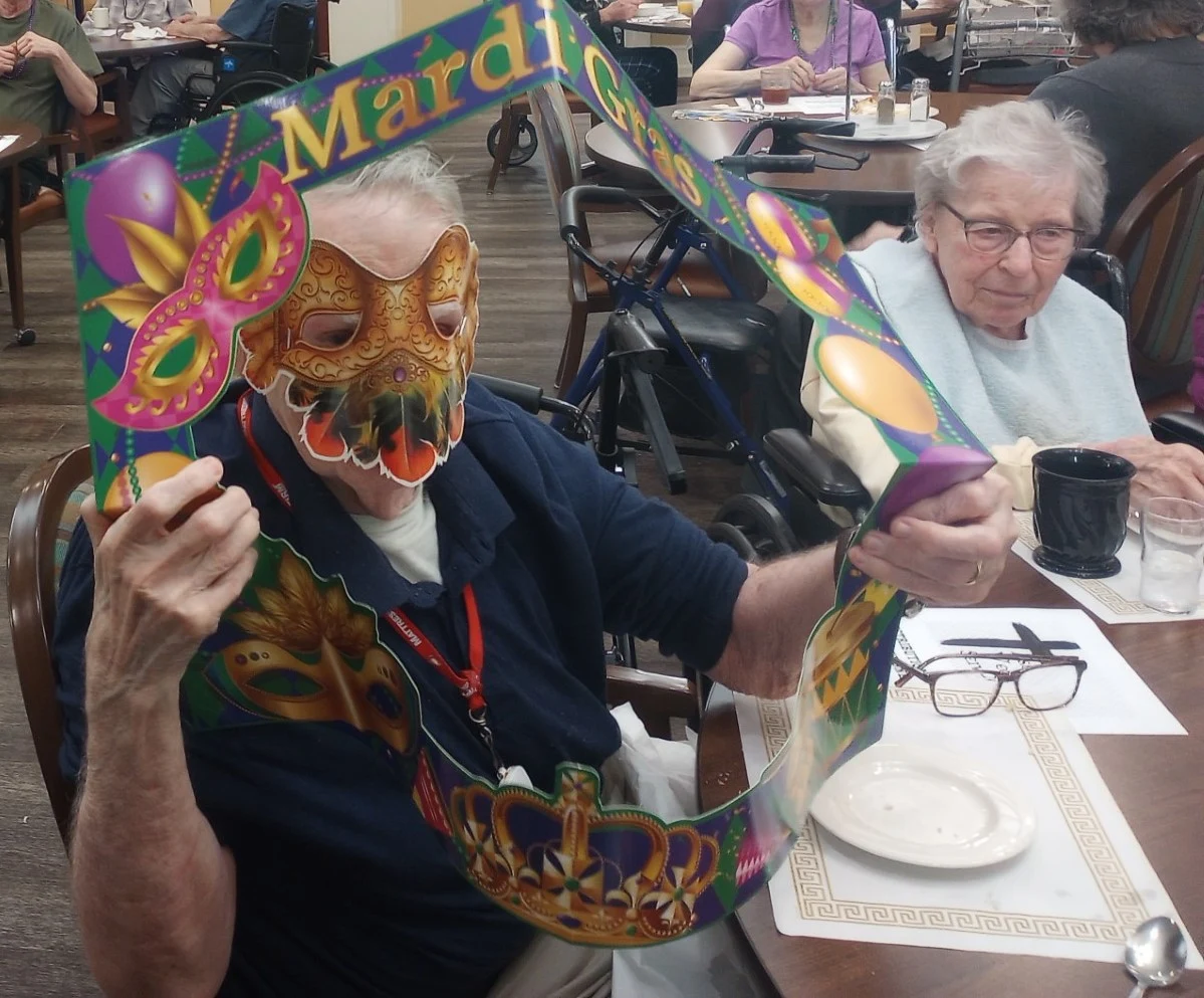 American House Sterling Heights, senior living community offering independent living and respite care in Sterling Heights, MI, residents celebrating Mardi Gras