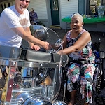 American House Stone senior living community offering independent living and respite care in Rochester Hills, MI, resident showing excitement as she looks at a motorcycle