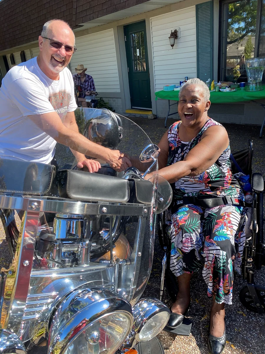 American House Stone senior living community offering independent living and respite care in Rochester Hills, MI, resident showing excitement as she looks at a motorcycle