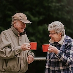 couple cheersing coffee outside