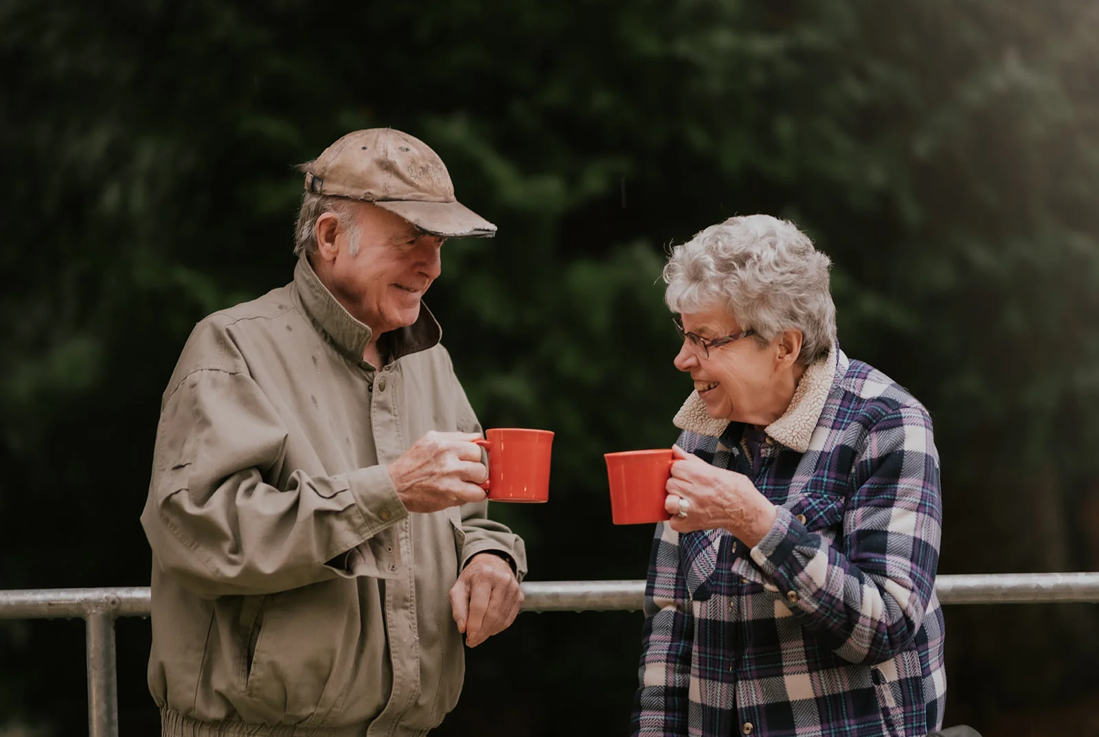 couple cheersing coffee outside