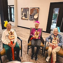 Featherstone at Hickory Hill smiling resident during an activity