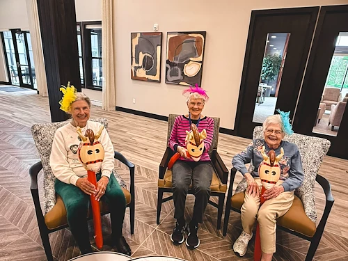 Featherstone at Hickory Hill smiling resident during an activity