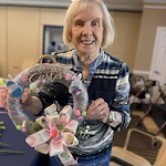 A Gaines Park resident showing off her wreath from the monthly wreath making activity