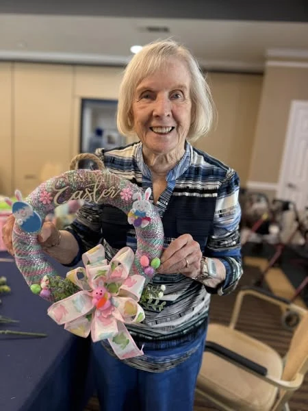 A Gaines Park resident showing off her wreath from the monthly wreath making activity