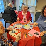 Charter Senior Living of Fredericksburg, Virginia, residents enjoying good community and a creative art project