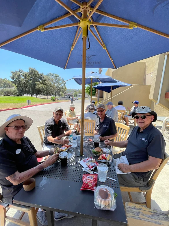 Covenant Living at Mount Miguel in Spring Valley, CA, residents enjoy dining together during a golf outing