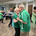 A couple of Verena at Leander residents celebrating St. Patrick's Day by sharing a dance