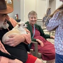 Suzanne Elise Assisted Senior Living in Seaside, Oregon resident holding a dog