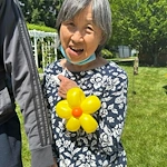 Charter Senior Living of Columbia smiling resident with balloon creation
