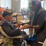 American House Farmington Hills, senior living community offering independent living, assisted living, memory care, and respite care in Farmington Hills, MI, resident bonding with a staff member