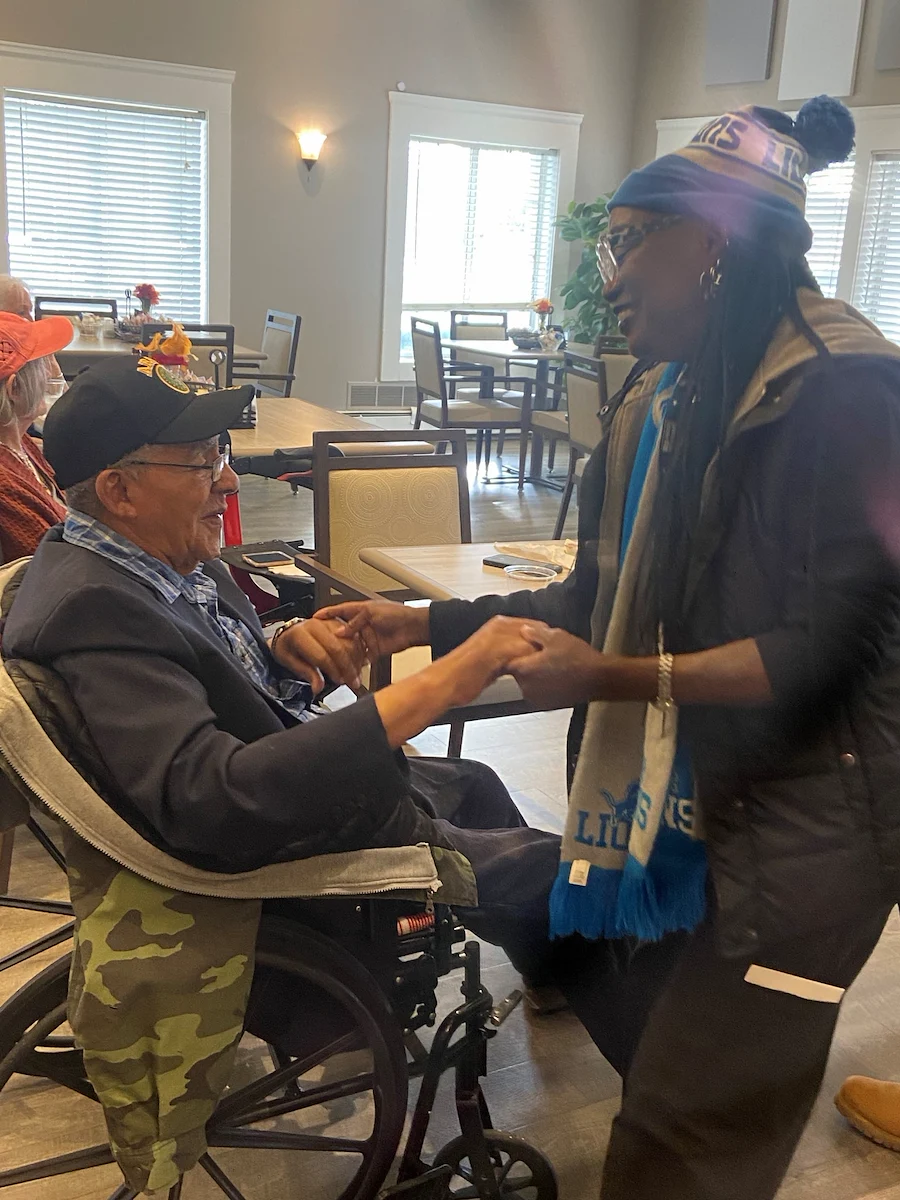 American House Farmington Hills, senior living community offering independent living, assisted living, memory care, and respite care in Farmington Hills, MI, resident bonding with a staff member