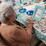 Fieldstone Memory Care of Yakima resident having fun with a painting activity