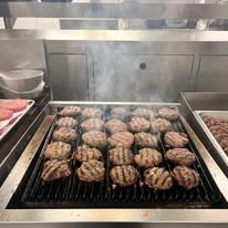 burgers on the grill at Fairview Estates Gracious Retirement Living Hawthorn Senior Independent Living in Hopkinton, Massachusetts