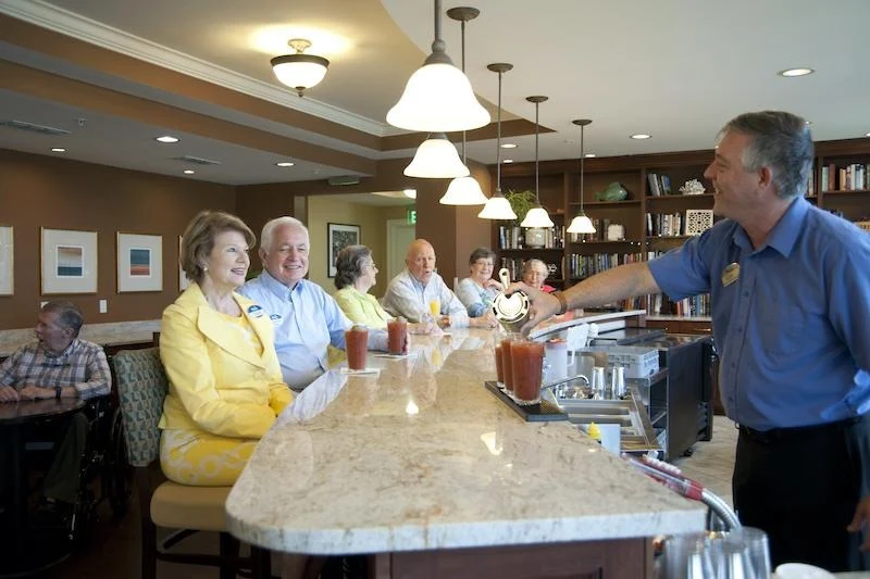 Allegro Hyde Park, senior living community offering independent living, assisted living, and respite care in Tampa, FL, residents enjoying a happy hour and good company