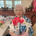 Mulligan Park Gracious Retirement Living Hawthorn Senior Independent Living in Tallahassee, Florida resident holding a flower wreath craft