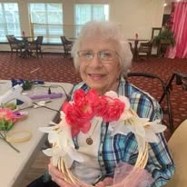 Mulligan Park Gracious Retirement Living Hawthorn Senior Independent Living in Tallahassee, Florida resident holding a flower wreath craft