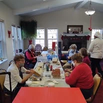 Summerville Estates Gracious Retirement Living Hawthorn Senior Independent Living in Summerville, South Carolina residents making festive gingerbread houses