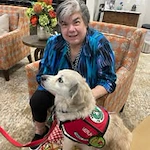 Orchard Heights Gracious Retirement Living Hawthorn Senior Independent Living in Clermont, Florida resident petting a service dog