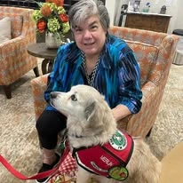 Orchard Heights Gracious Retirement Living Hawthorn Senior Independent Living in Clermont, Florida resident petting a service dog