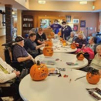 Ascension Living Lakeshore at Siena Memory Care Senior Living in Racine, Wisconsin residents carving pumpkins for Halloween