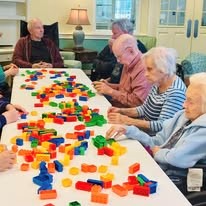 seniors playing with legos at Serenades at Longwood
