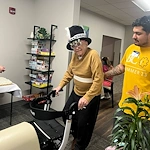 Kidron Bethel Village senior living community and continuing care retirement community (CCRC) offering independent living, assisted living, and respite care in North Newton, KS, smiling resident with festive hat for a celebration