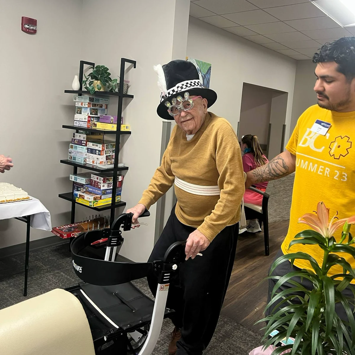 Kidron Bethel Village senior living community and continuing care retirement community (CCRC) offering independent living, assisted living, and respite care in North Newton, KS, smiling resident with festive hat for a celebration