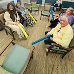 Bennett Place in New Albany, IN, residents staying active with a fun activity using pool noodles