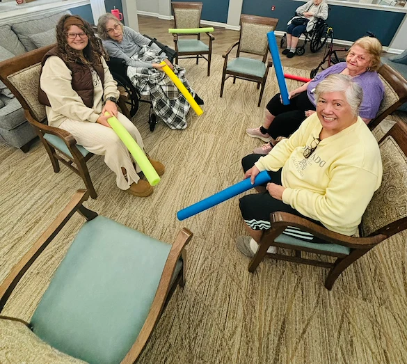 Bennett Place in New Albany, IN, residents staying active with a fun activity using pool noodles