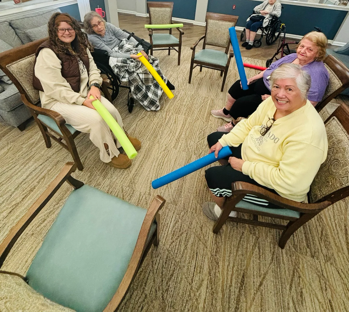 Bennett Place in New Albany, IN, residents staying active with a fun activity using pool noodles