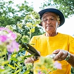 The Mansion at Rosemont Senior Living in Rosemont, PA, resident staying active and trimming flowers
