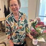 The Blake At Bossier City resident with her creation of a painted vase and spring bouquet