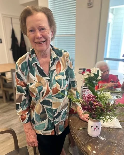 The Blake At Bossier City resident with her creation of a painted vase and spring bouquet