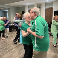A couple of Verena at Gilbert residents celebrating St. Patrick's Day by sharing a dance
