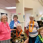 Glenmoore Gracious Retirement Living Hawthorn Senior Independent Living in Happy Valley, Oregon residents at a Hawaiian party