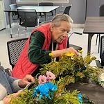 Bartlett Reserve independent living in Durham, NC, resident enjoying floral arrangement activity