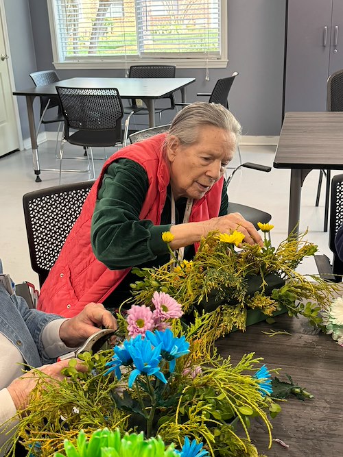 Bartlett Reserve Independent Living resident enjoys activity - arranging flowers