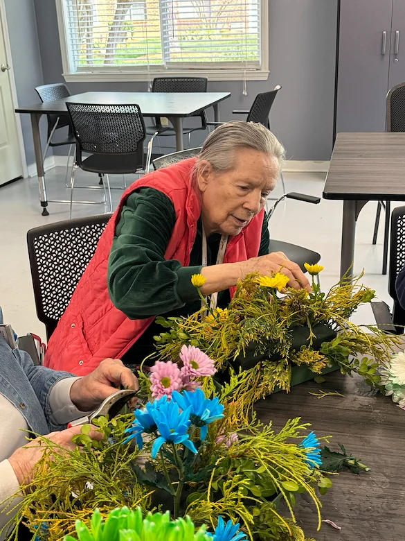 Bartlett Reserve independent living in Durham, NC, resident enjoying floral arrangement activity