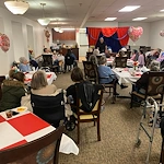 Prime Healthcare Senior Living – Fox Knoll Village in Aurora, IL, residents enjoy an entertaining performance from a magician