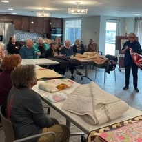 Ovation Heartwood Preserve Senior Living in Omaha, Nebraska residents watching entertainment