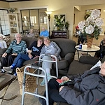 American House Stone senior living community offering independent living and respite care in Rochester Hills, MI, residents spending time together as they sit in the community living room