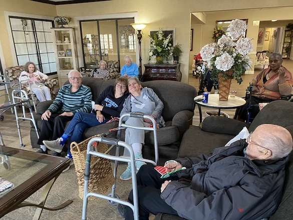 American House Stone senior living community offering independent living and respite care in Rochester Hills, MI, residents spending time together as they sit in the community living room