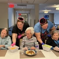 Ascension Living Bethlehem Woods Village Senior Living in La Grange Park, Illinois residents trying new food at a cultural event