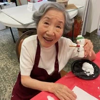 Bella Vista Gracious Retirement Living Hawthorn Senior Independent Living in Asheville, North Carolina resident showing off snowman arts and crafts
