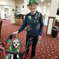 Maple Ridge Gracious Retirement Living Hawthorn Senior Independent Living in Cedar Park, Texas resident dressed up for St. Patrick's Day walking her dog