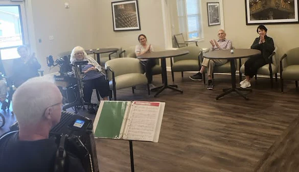 Pinnacle Grove's Senior Living residents enjoying an accordion performance