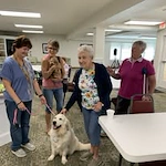 The Lodge at Wake Forest Gracious Retirement Living Hawthorn Senior Independent Living in Wake Forest, North Carolina residents petting a service animal